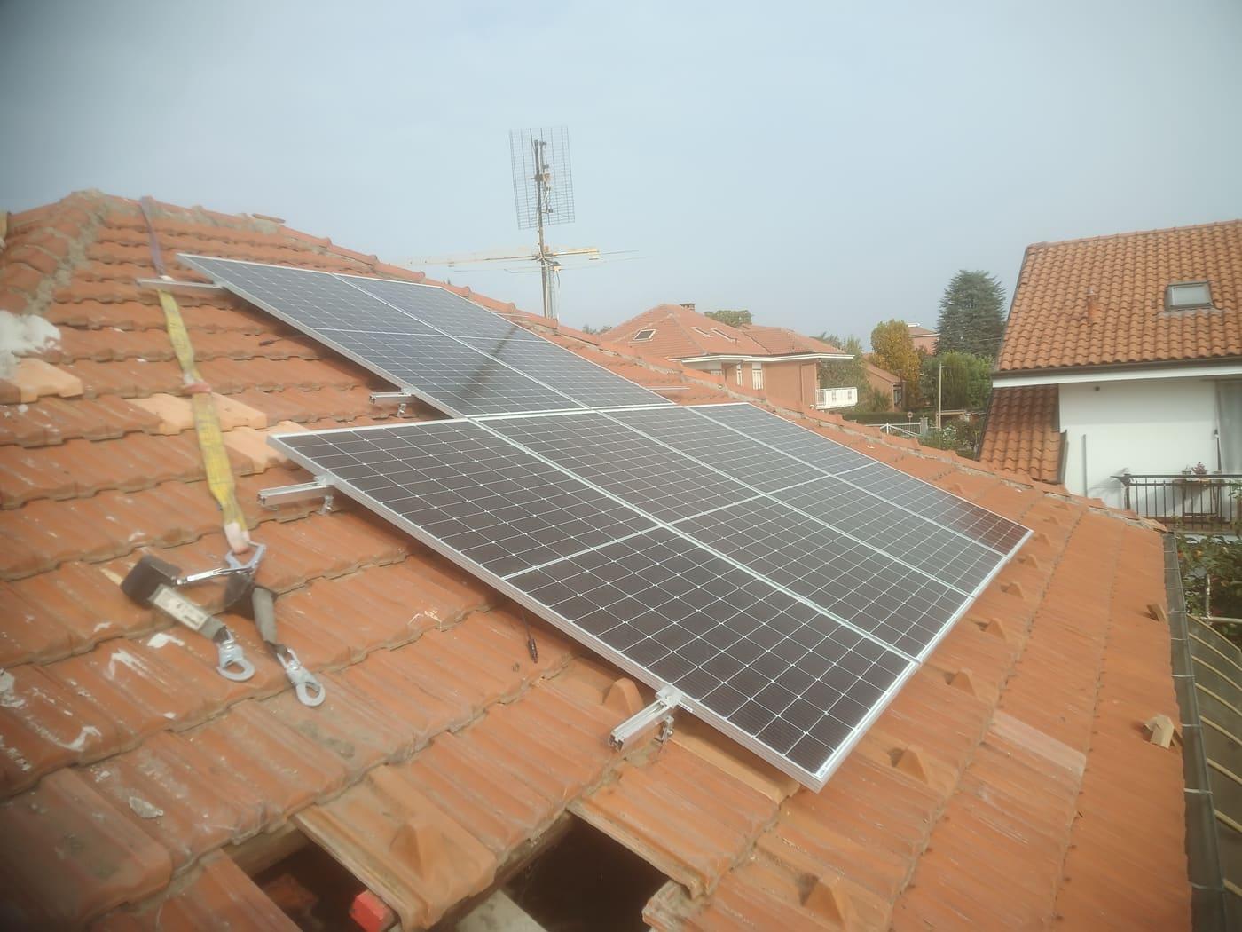 Pannelli su tetto in coppi con imbracatura di sicurezza in primo piano