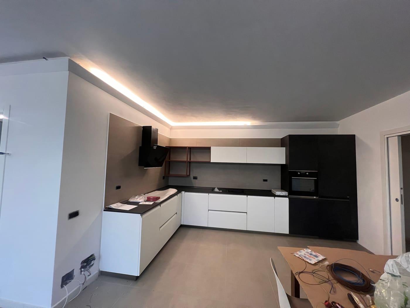 Cucina con linea di luce continua lungo il perimetro del soffitto